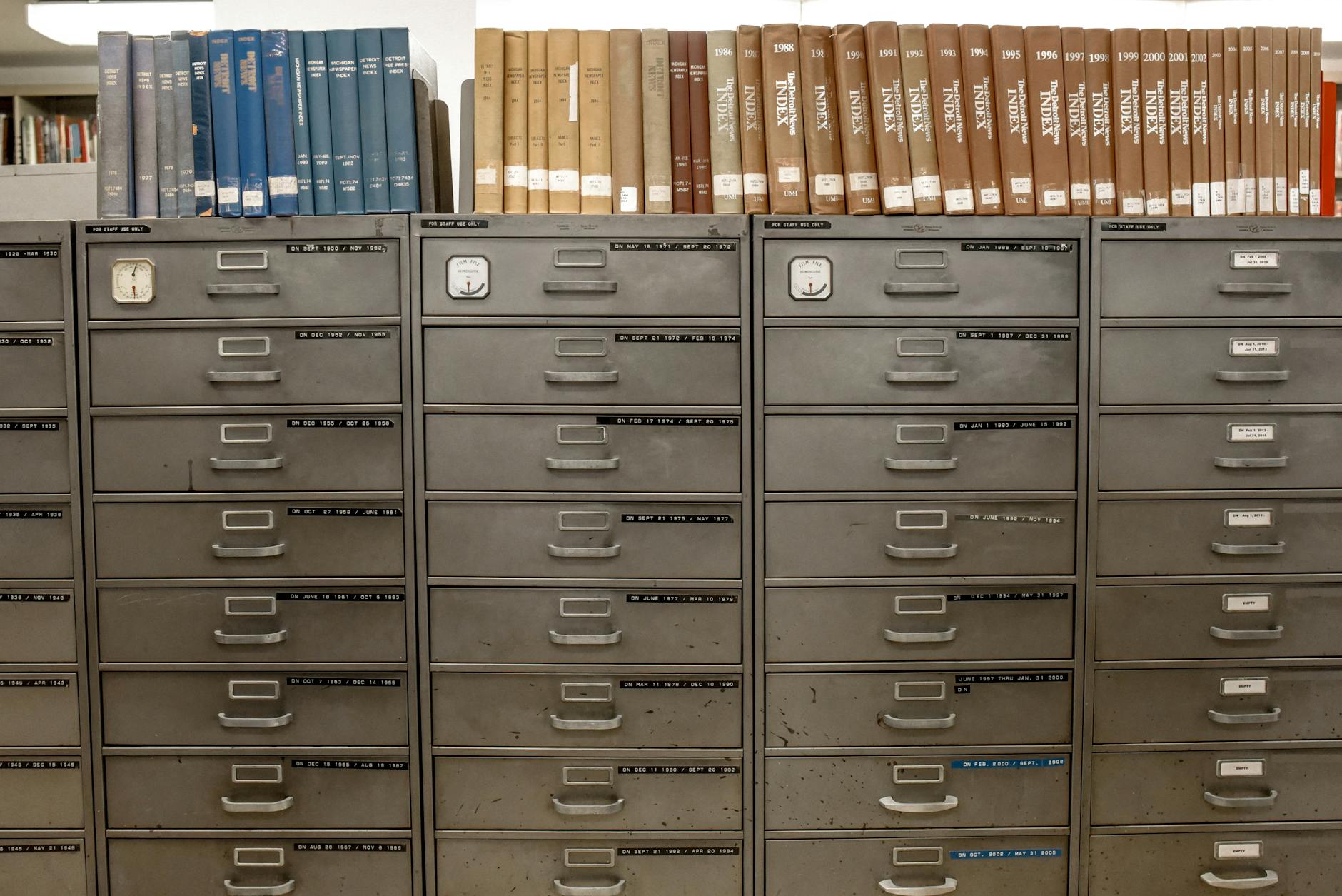 Rows of filing cabinets and tax record books, representing organized documentation needed for freelancers and small business owners to claim deductions.